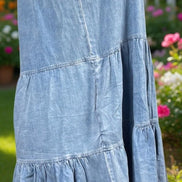 Shopin La denim summer dress displayed on a hanger, featuring a casual sleeveless design with a light blue wash and button front.