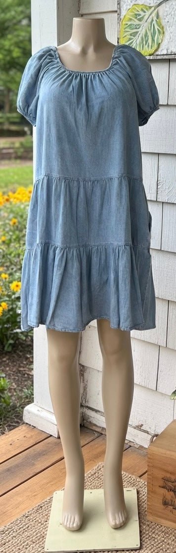 Light blue denim summer dress from Shopin La with adjustable straps and a relaxed fit, perfect for warm weather.