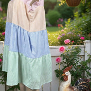 Multi-colored striped sundress from Shopin La featuring a flowy design and thin shoulder straps on a model.