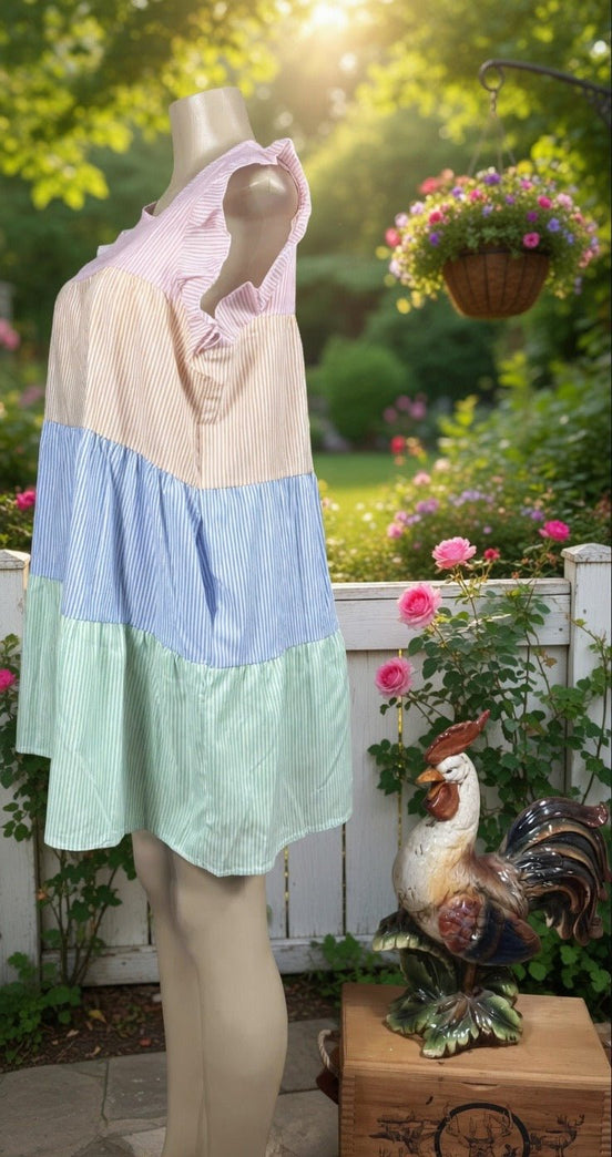 Multi-colored striped sundress from Shopin La featuring a flowy design and thin shoulder straps on a model.