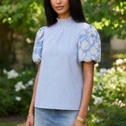 TCEC puff sleeve top featuring airy fabric, stylish puffed sleeves, and a fitted silhouette for a trendy, feminine look.