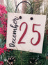 Red December 25th novelty sign by The Country Roost with festive holiday decor and bold lettering for seasonal display.