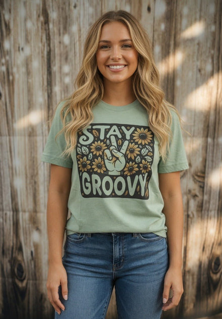Stay Groovy sunflower peace sign graphic T-shirt from The Lyrical Spirit, LLC featuring a colorful sunflower and peace symbol design.