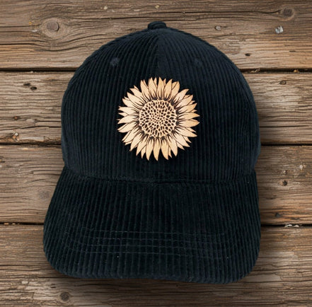 Trendy Tee Co. corduroy cap featuring a sunflower leather patch, casual and stylish accessory for everyday wear.