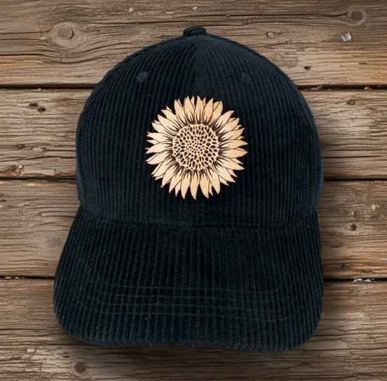 Trendy Tee Co. corduroy cap featuring a sunflower leather patch, casual and stylish accessory for everyday wear.