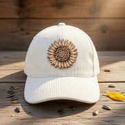 Trendy Tee Co. corduroy cap featuring a sunflower leather patch, stylish accessory for casual and outdoor wear.