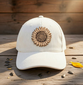 Trendy Tee Co. corduroy cap featuring a sunflower leather patch, stylish accessory for casual and outdoor wear.
