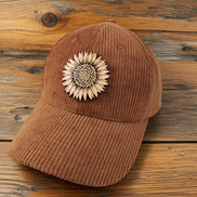 Trendy Tee Co. corduroy cap featuring a sunflower leather patch, casual and stylish headwear for everyday wear.