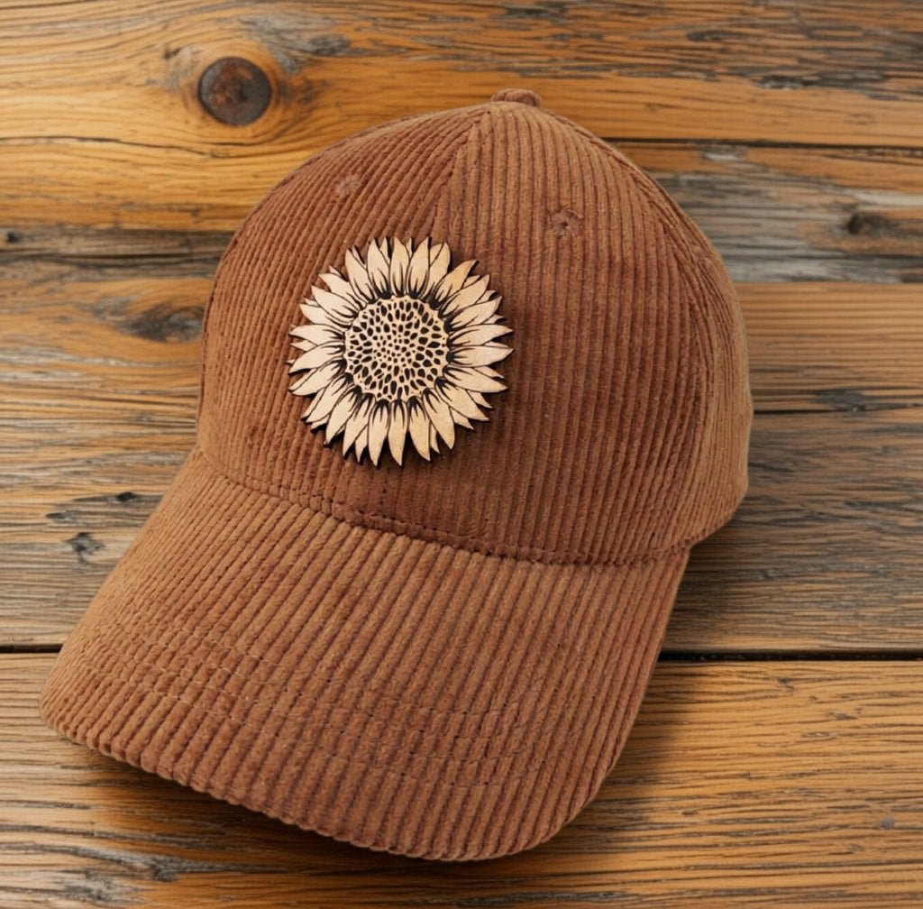 Trendy Tee Co. corduroy cap featuring a sunflower leather patch, casual and stylish headwear for everyday wear.
