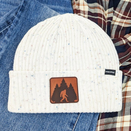 Tweed beanie hat with a Bigfoot leather patch logo, trendy accessories by Trendy Tee Co. for a stylish winter look.