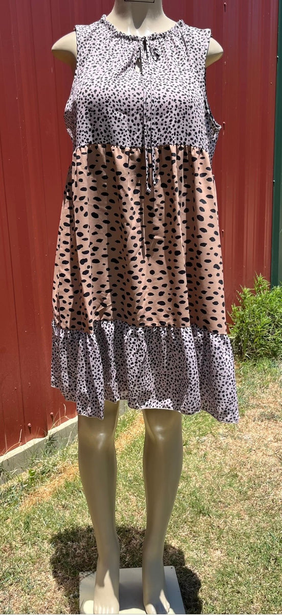 Animal print sleeveless tiered dress by Vanilla Monkey, showing layered fabric and vibrant animal pattern on lightweight fabric.