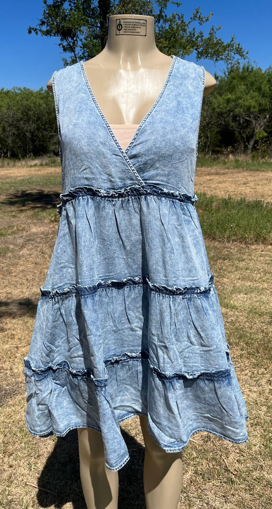 Vanilla Monkey denim sundress with adjustable straps and pockets, displayed on a hanger against a neutral background.