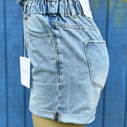 KanCan denim shorts featuring distressed details and a high-waist fit, shown on a model with casual styling.