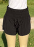 42POPS windbreaker track shorts in black with elastic waistband and side pockets, suitable for running and casual wear.