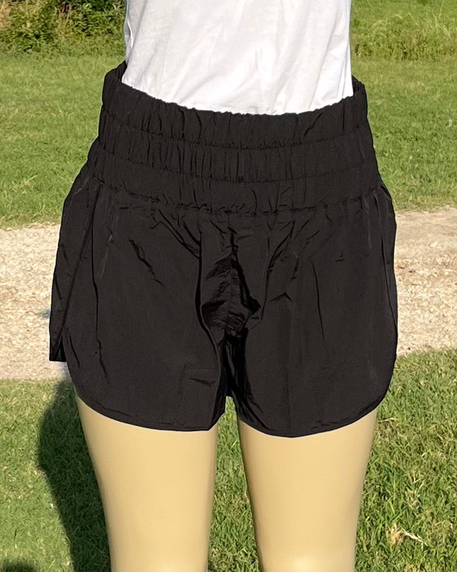 42POPS windbreaker track shorts in black with elastic waistband and side pockets, suitable for running and casual wear.