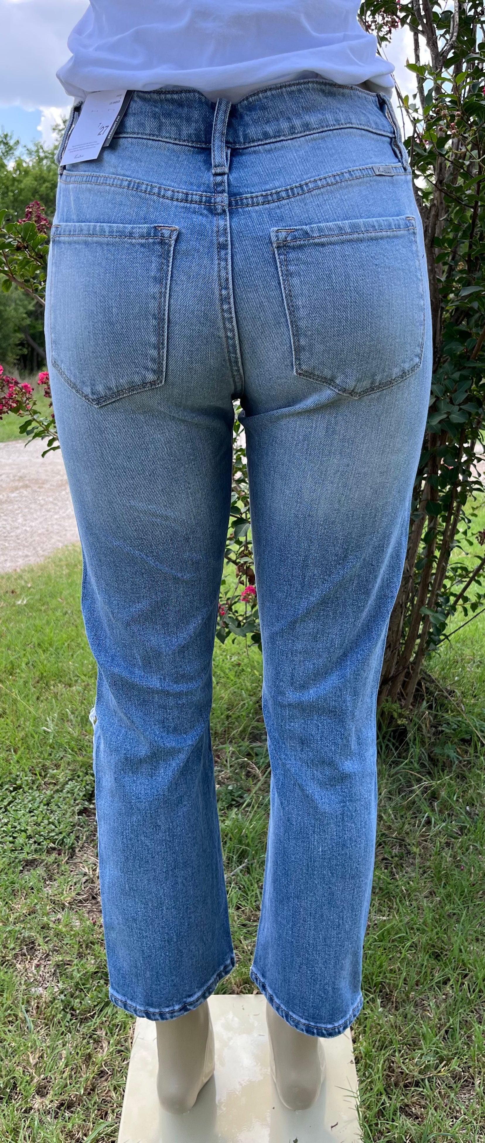 Pair of KanCan capris jeans showing a close-up of denim fabric with classic stitching and a slightly distressed style.